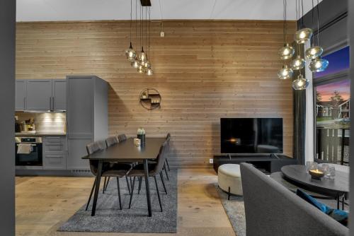 a kitchen and dining room with a table and chairs at New Nice apartment Trysil alpine lodge with the lift right outside in Trysil