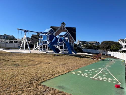 a playground with a slide in a park at Life O Rily in Duck
