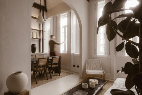 a man standing in a living room looking out the window at Beige Tranquil Escape by the Sea in Matosinhos
