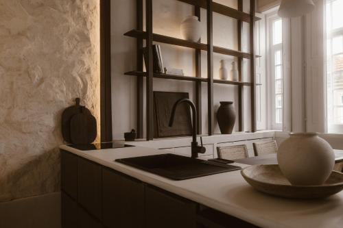 a kitchen counter with a sink and a window at Beige Tranquil Escape by the Sea in Matosinhos