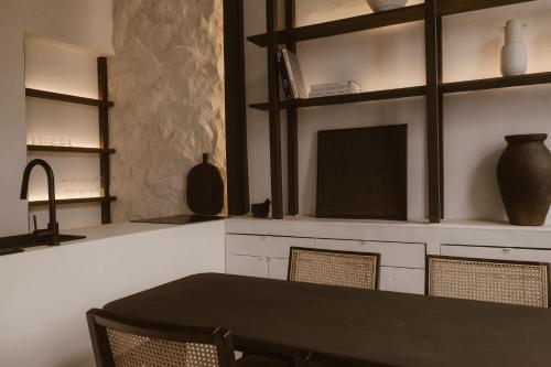 a dining room with a table and chairs and shelves at Beige Tranquil Escape by the Sea in Matosinhos