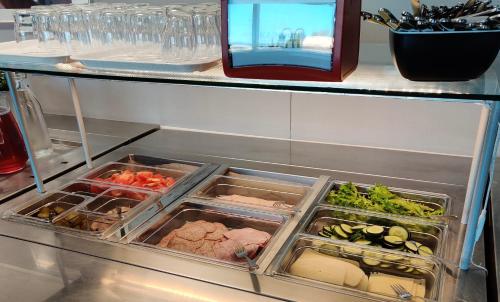 a refrigerator filled with lots of different types of food at Hotelli Kainuunportti in Kajaani