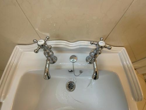 a white bath tub with a silver faucet at Lake View Doubleroom&private Bath in Castlebar