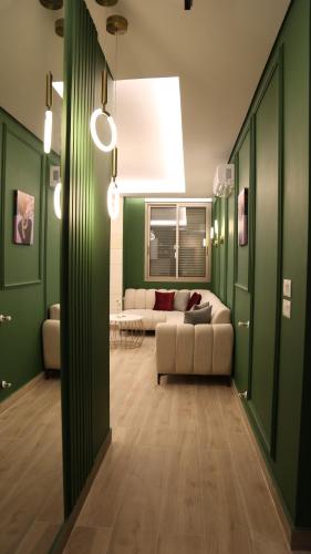 a living room with green walls and a couch at BView in Ehden