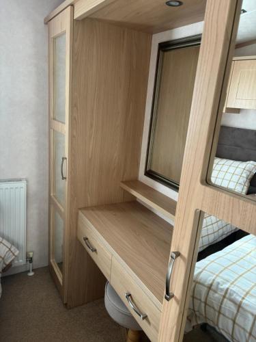 a bedroom with two bunk beds and a toilet at Knightsbridge 2 Bedroom Lodge in Lytchett Minster