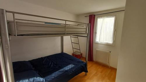a bedroom with a bunk bed and a window at Chez Sofia T3 view port private parking and pool in Cap d'Agde