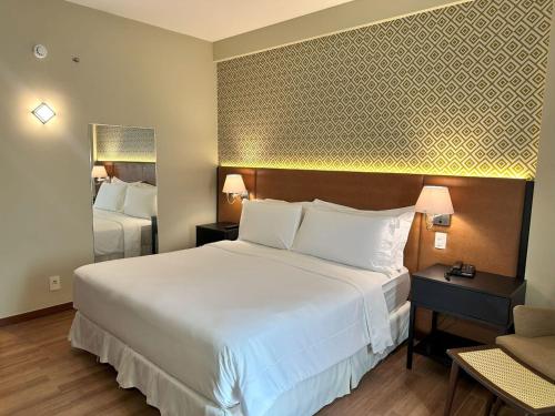 Postel nebo postele na pokoji v ubytování Wish Hotel da Bahia