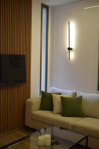 a living room with a couch and a clock on the wall at BView in Ehden