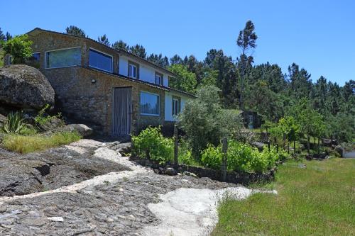 a house on a hill with a yard at Casa do Monte in Castro Daire