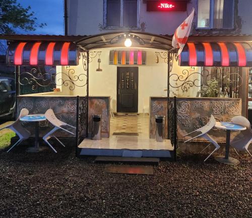 a small house with two chairs and a door at Hotel Nike in Tsalka