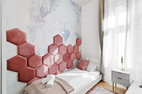 a bedroom with a bed with a pink headboard at Elegant Room Near Prater & City Center in Vienna