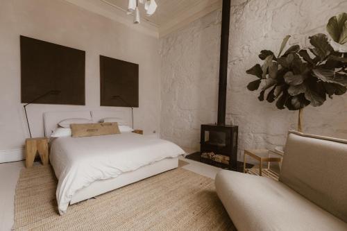 a white bedroom with a bed and a fireplace at Beige Tranquil Escape by the Sea in Matosinhos