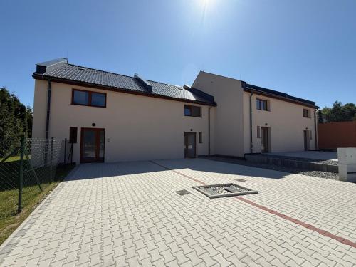 a house with a driveway in front of it at Objev Jeseníky Velké Losiny in Velké Losiny
