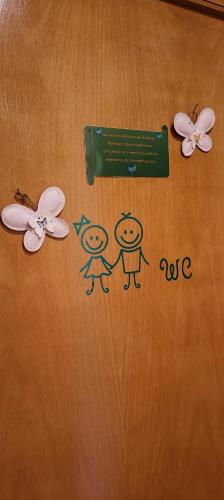 a drawing of two people and butterflies on a table at Rooms_Heart Apartment in Faro