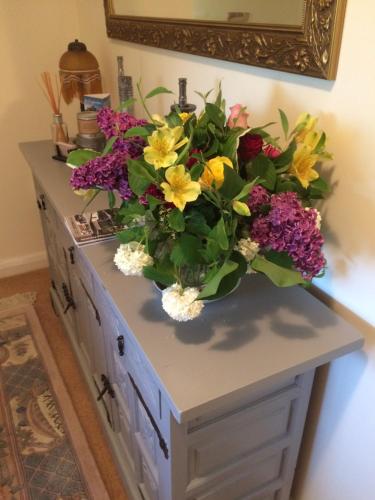 a bouquet of flowers sitting on top of a cabinet at Ballacowell in Sulby