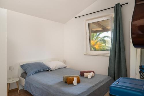 a bedroom with a bed with two towels on it at Luce Apartments in Ližnjan
