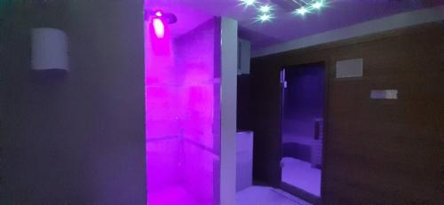 a bathroom with pink lights and a mirror at Casa Ciclamino Val Di Sole 10 pax 7 nights in Cassana