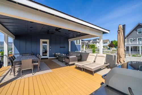 a patio with a couch and a table and chairs at Lake Escape #99 in Chelan