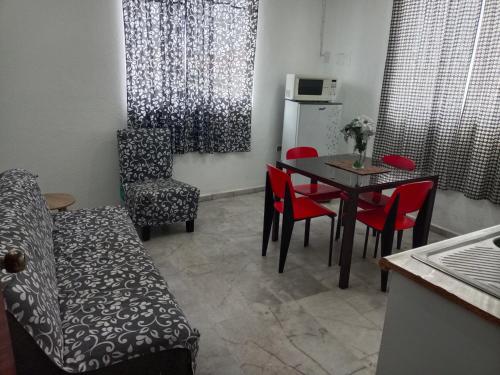 a kitchen with a table and chairs and a refrigerator at Depa 11, Torre Belén, Mazatlán in Mazatlán