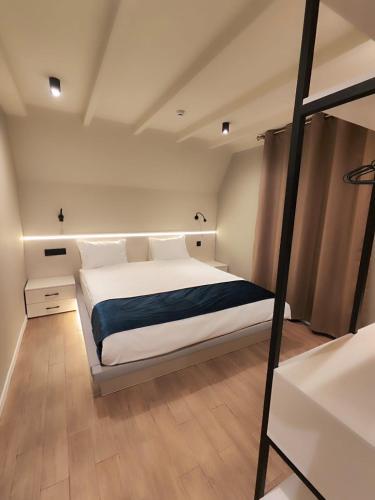 a bedroom with a large white bed in a room at Mountain Resort Gabala in Nourkyshlak