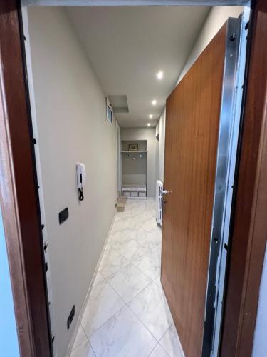 an office hallway with a door and a tile floor at Gialò Vibe in Alassio
