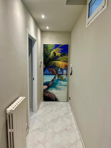a hallway with a palm tree mural on the wall at Gialò Vibe in Alassio