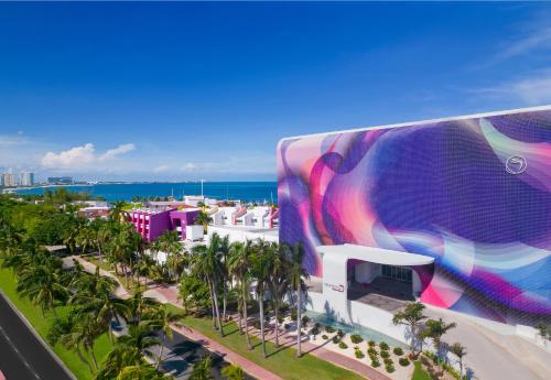 a mural on the side of a building at a resort at Temptation Cancun Resort - All Inclusive - Adults Only in Cancún