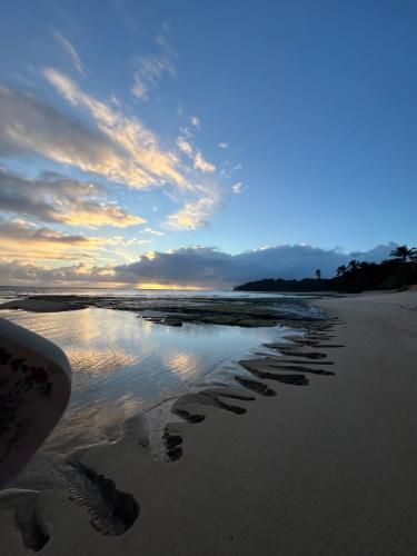 a group of footprints in the sand on a beach at Pousada Marina de Boipeba in Ilha de Boipeba