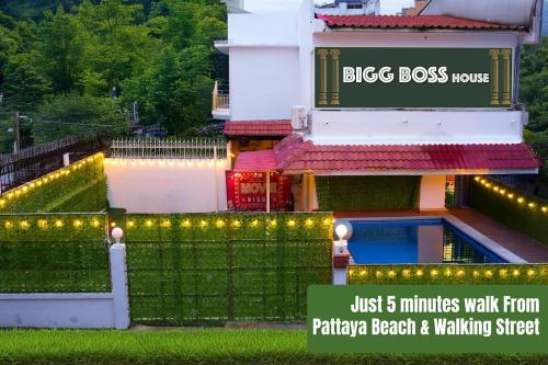 a building with a sign that reads just minutes walk from platinum beach walking at BIGG BOSS house near Walking St in Pattaya South