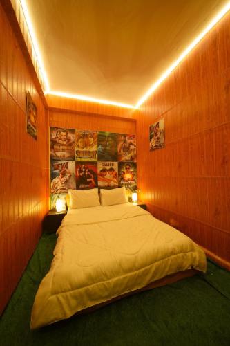 a bedroom with a large bed in a wooden wall at BIGG BOSS house near Walking St in Pattaya South