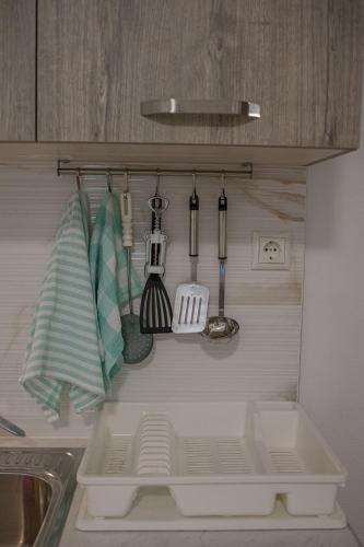 a kitchen counter with a sink and some utensils at Gatzea Eden Garden - DELUXE Δίκλινο δωμάτιο in Kato Gatzea