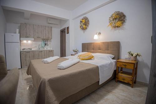 a bedroom with a bed with two pillows on it at Gatzea Eden Garden - DELUXE Δίκλινο δωμάτιο in Kato Gatzea