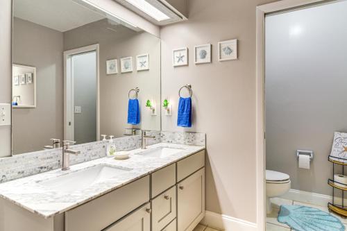 a bathroom with two sinks and a toilet at 4 Mi to Beach Sunny Seminole Home with Pool in Seminole