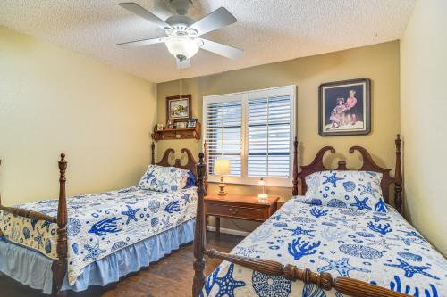 a bedroom with two beds and a ceiling fan at 4 Mi to Beach Sunny Seminole Home with Pool in Seminole
