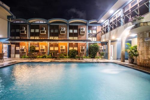 a swimming pool in front of a building at night at Amuarama Hotel in Fortaleza