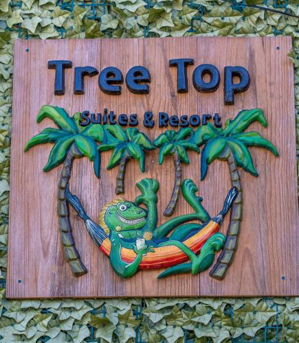 a tree top suites and resort sign with a frog at Palm Luxury King Suite, Pool, ocean views, beach short walk West Bay West End in West Bay