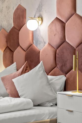 a bedroom with a bed with a pink headboard at Elegant Room Near Prater & City Center in Vienna