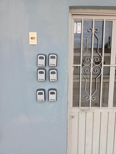a door to a building with four appliances on it at Depa 12 Aceso Directo con 3 recámaras in Mazatlán