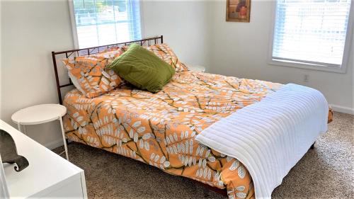 a bedroom with a bed with a comforter and pillows at 208 Pontaxit Avenue, North Cape May in North Cape May