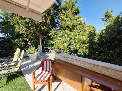 a pair of chairs sitting on a railing on a patio at Relax Dream Villa-House, Apartement, Studio in Kallithea Halkidikis