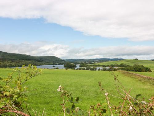 a green field with a river in the distance at Knockendoch in Dumfries