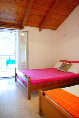 a bedroom with two bunk beds and a window at Psarou Thalassa Studios in Amoudi