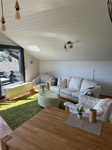 a living room with a couch and a table at Ferienwohnung Miesseler in Kall