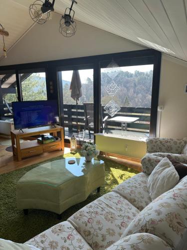 a living room with a couch and a table at Ferienwohnung Miesseler in Kall