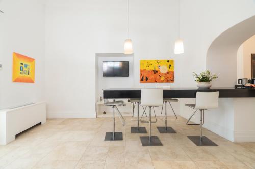 a dining room with a black table and chairs at Villa Magia in Positano