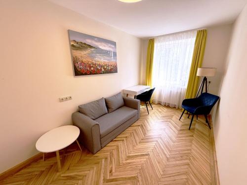 a living room with a couch and a table at ZB Apartment in Rēzekne
