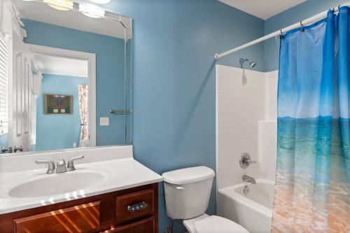 a bathroom with a sink and a toilet and a shower at Petes Place in Kitty Hawk