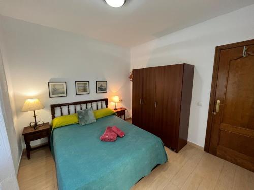 a bedroom with a large bed and a wooden cabinet at Villa Alcázar in San Pedro del Pinatar