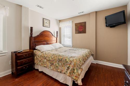 a bedroom with a bed and a flat screen tv at Petes Place in Kitty Hawk