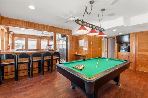 a billiard room with a pool table and a bar at Petes Place in Kitty Hawk